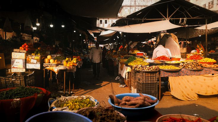 Traders and sacks of produce at an Indian wholesale mandi